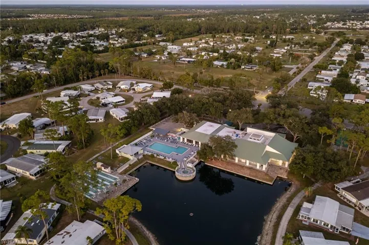 View of property location with a pool area and nearby suburban area