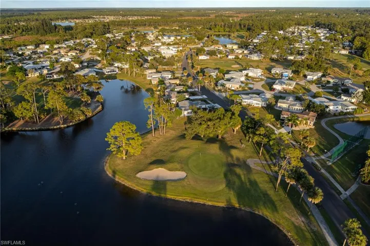View of property location with a golf club and nearby suburban area