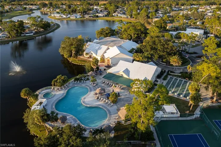 Bird's eye view of a pool area and a nearby body of water