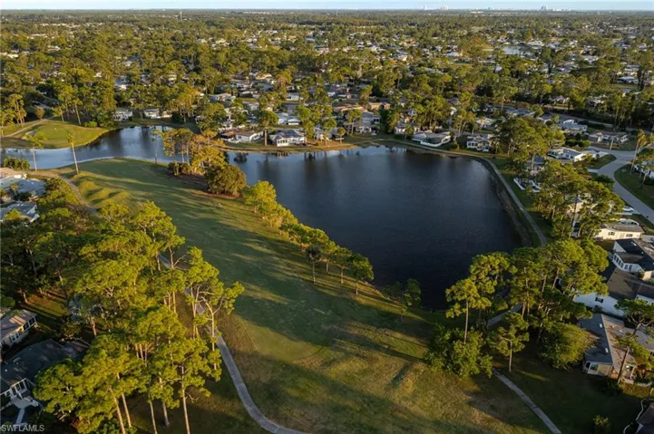 Aerial view of property's location with a large body of water and nearby suburban area