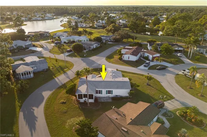 Aerial overview of property's location with nearby suburban area and a nearby body of water