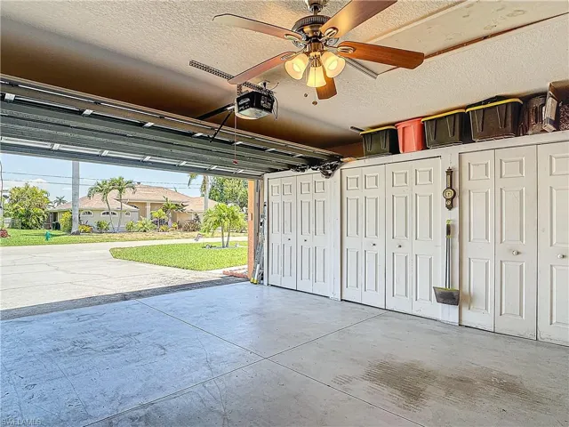 Garage featuring a garage door opener and ceiling fan