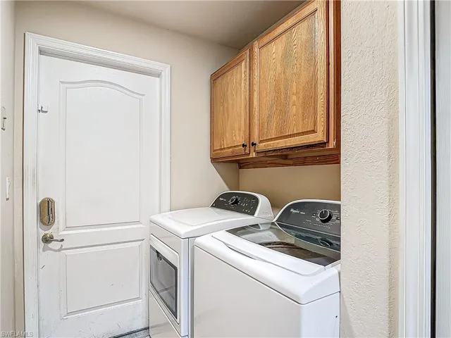 Laundry room with washer, dryer and cabinets