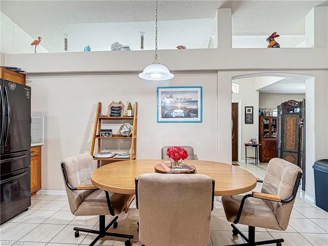 Dining room featuring a textured ceiling and light tile floors
