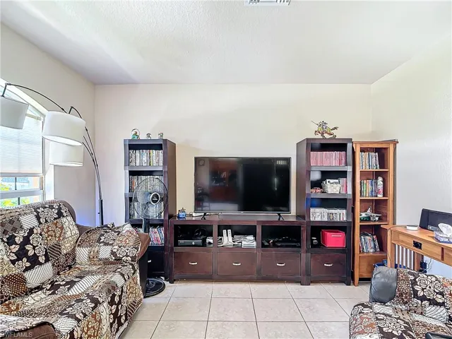 Tiled living room with a textured ceiling