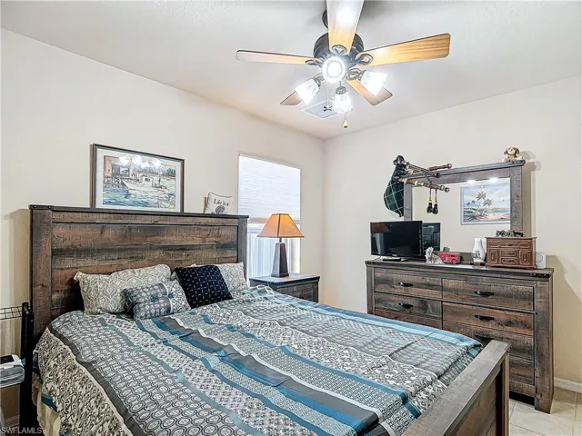 Tiled bedroom with ceiling fan