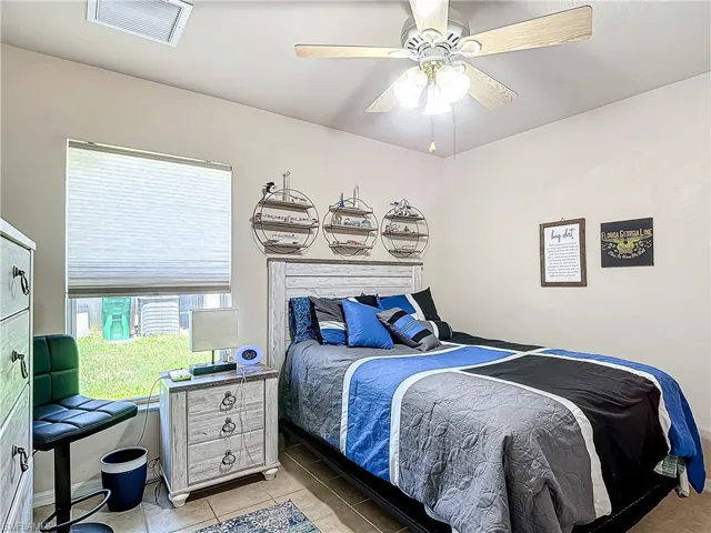 Tiled bedroom with ceiling fan