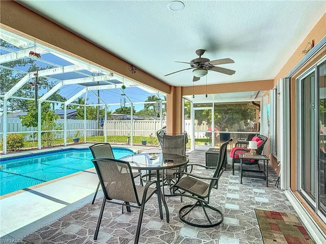 View of swimming pool with a patio area and ceiling fan