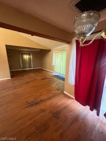 Spare room featuring hardwood / wood-style floors and a textured ceiling