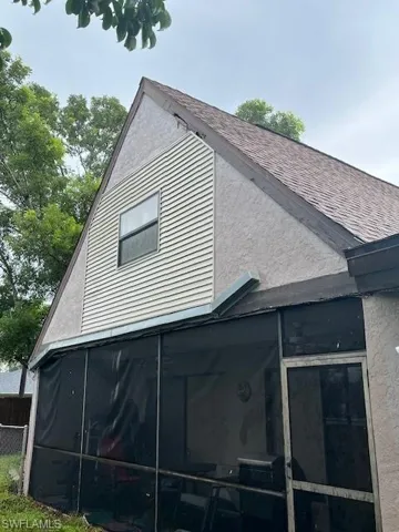 View of side of home with a sunroom