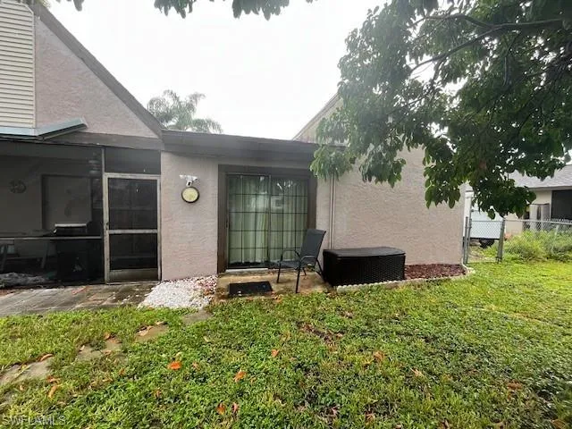 Rear view of property with a lawn