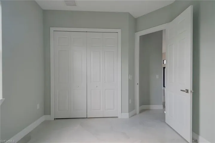Unfurnished bedroom featuring baseboards and a closet