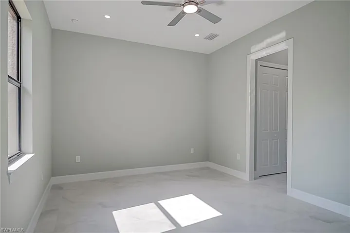 Empty room featuring plenty of natural light, a ceiling fan, and recessed lighting