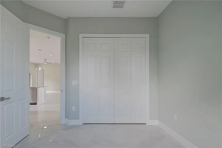 Unfurnished bedroom with a closet and baseboards