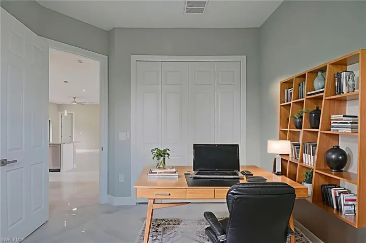 Office space with baseboards and a ceiling fan