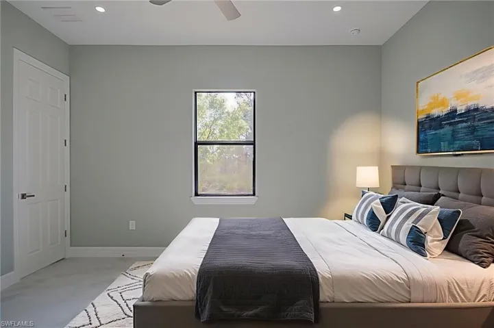 Bedroom with ceiling fan, recessed lighting, and concrete flooring