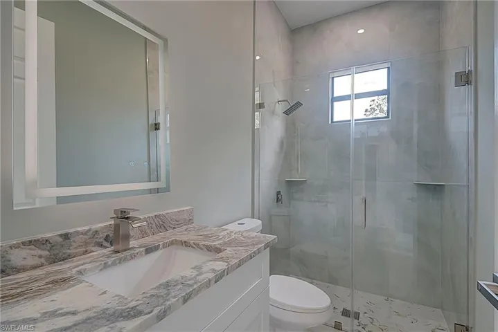 Full bathroom featuring vanity and a stall shower