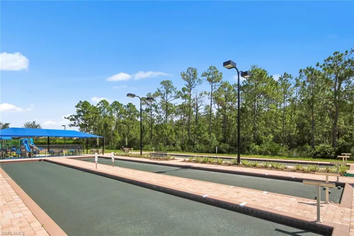 Bocce courts with playground in the background.