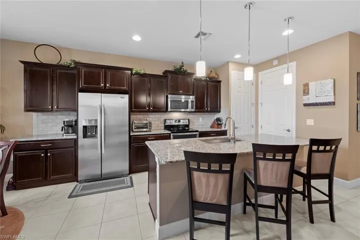 Kitchen with island and bar stools.
