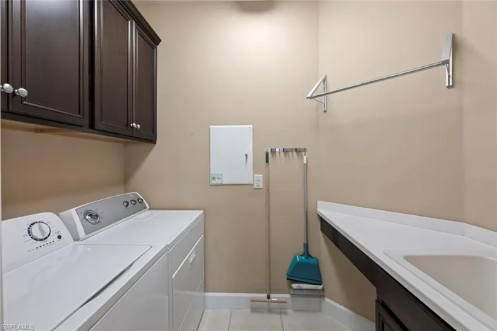 Laundry room with sink and storage.