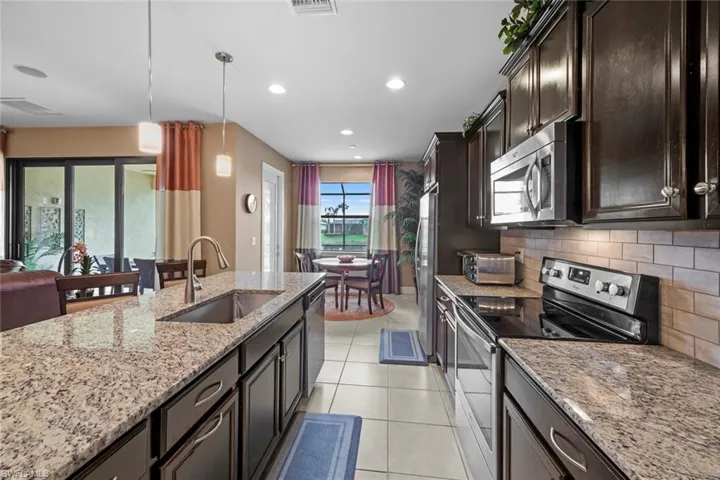Kitchen with abundant storage cabinets and large farmhouse sink.