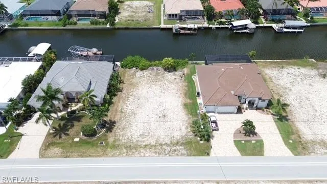 Vacant land parcel featuring direct canal frontage and an unobstructed street approach