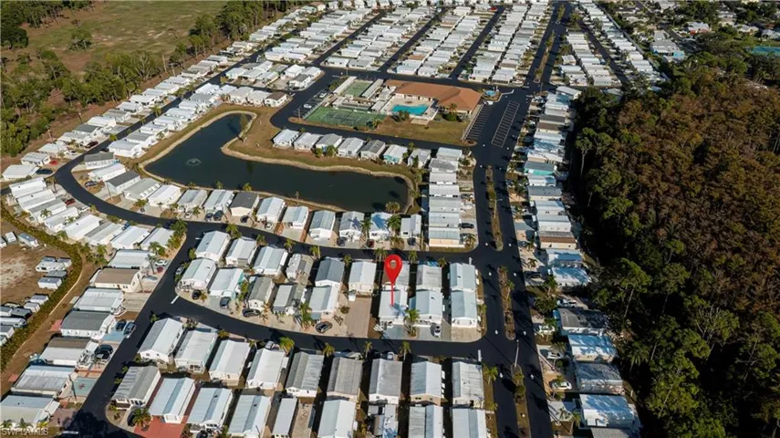 Aerial view of property and surrounding area featuring a nearby body of water