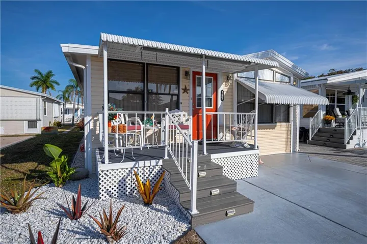 Manufactured / mobile home featuring a wooden deck and a patio