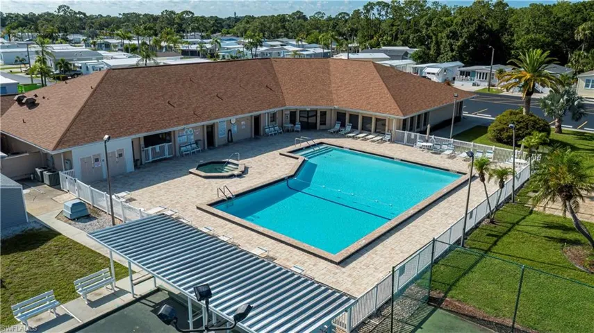 Community pool with a patio area, a fenced backyard, a community hot tub, and a residential view