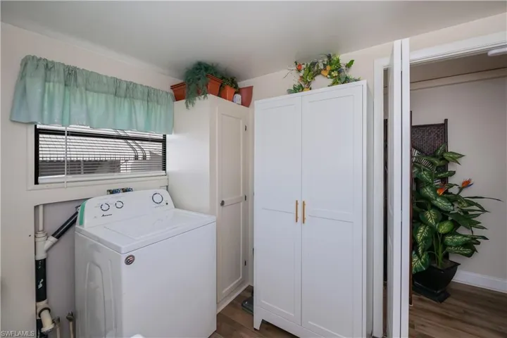 Laundry area featuring washer / clothes dryer and dark wood-style floors
