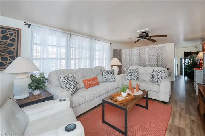 Living room featuring wood finished floors and a ceiling fan