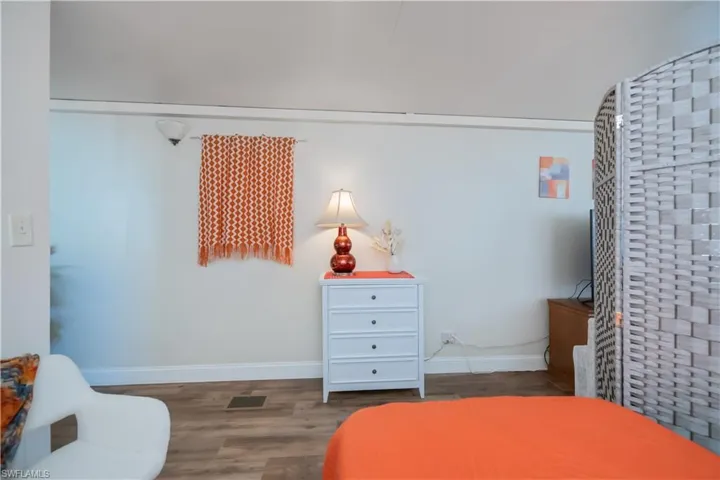 Bedroom featuring wood finished floors and baseboards