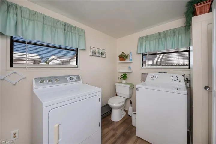 Half bath featuring dark wood finished floors and vanity