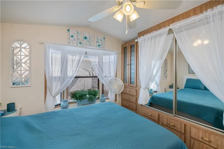 Bedroom with vaulted ceiling, ceiling fan, and a closet