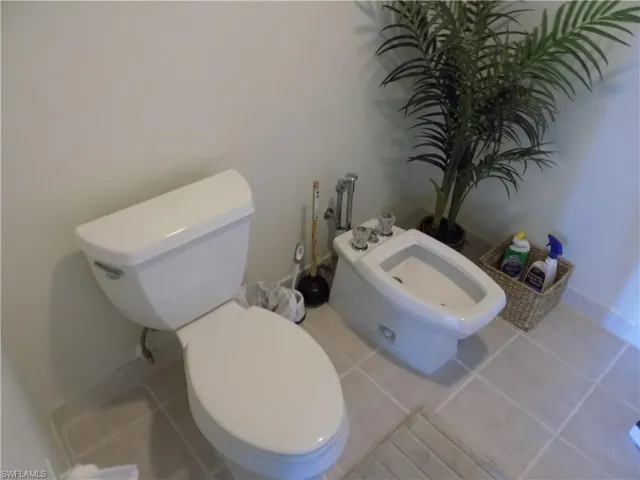 Bathroom featuring a bidet, toilet, and tile patterned floors