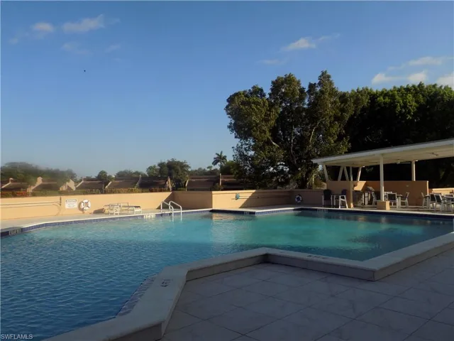 Community pool featuring a patio