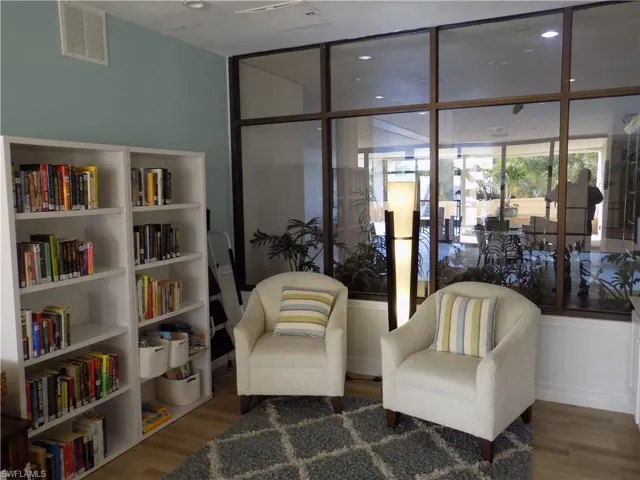 Sitting room with wood finished floors and expansive windows