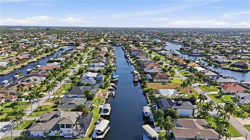 Aerial view of property's location with nearby suburban area and a large body of water