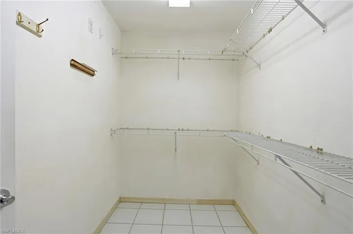 Spacious closet with light tile patterned flooring