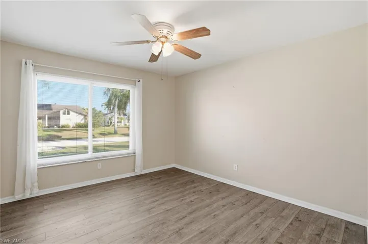 Unfurnished room featuring light wood-style floors and a ceiling fan