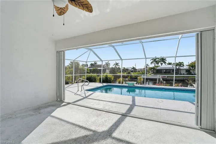 Outdoor pool featuring a lanai, a sunroom, and a patio area
