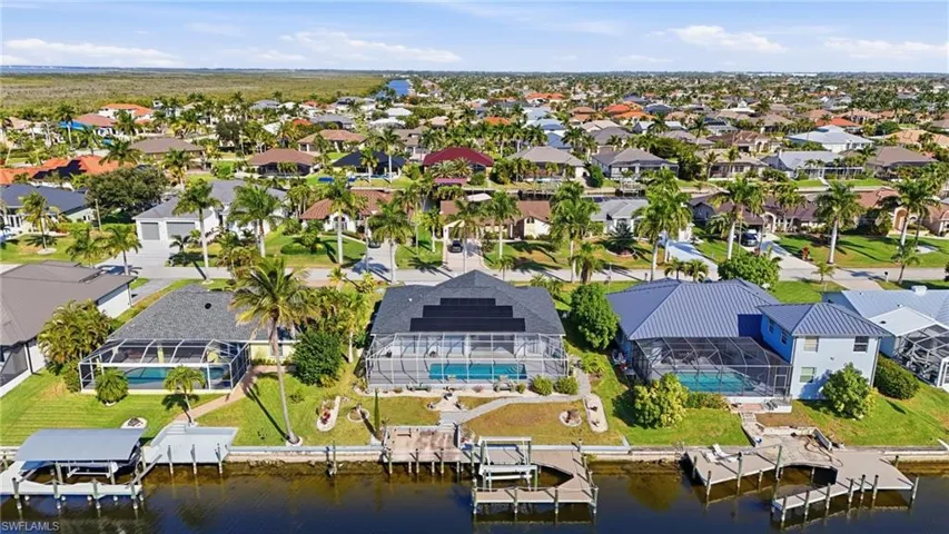 Aerial perspective of suburban area featuring a nearby body of water
