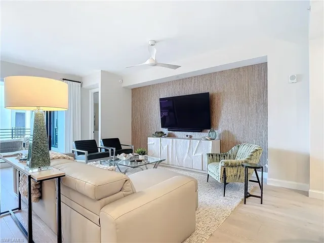 Living room with light wood-type flooring and ceiling fan