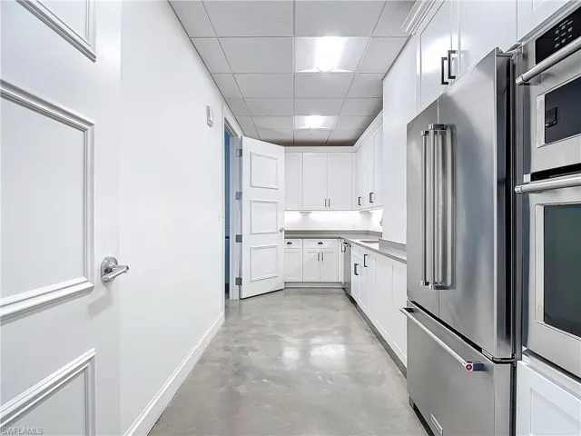 Kitchen featuring white cabinetry, a paneled ceiling, and stainless steel appliances