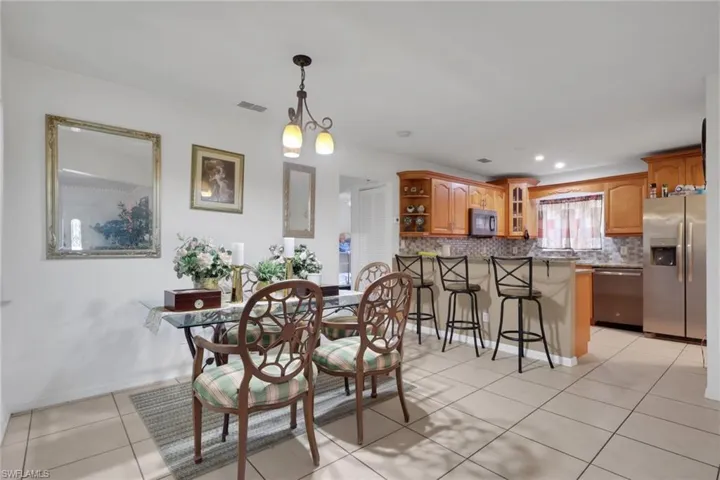 Dining area featuring light tile patterned flooring and recessed lighting