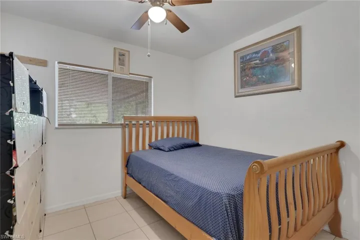Bedroom featuring a ceiling fan and light tile patterned flooring