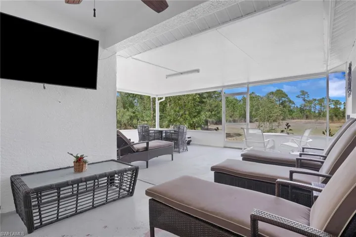 View of patio / terrace featuring an outdoor hangout area, ceiling fan, and a sunroom