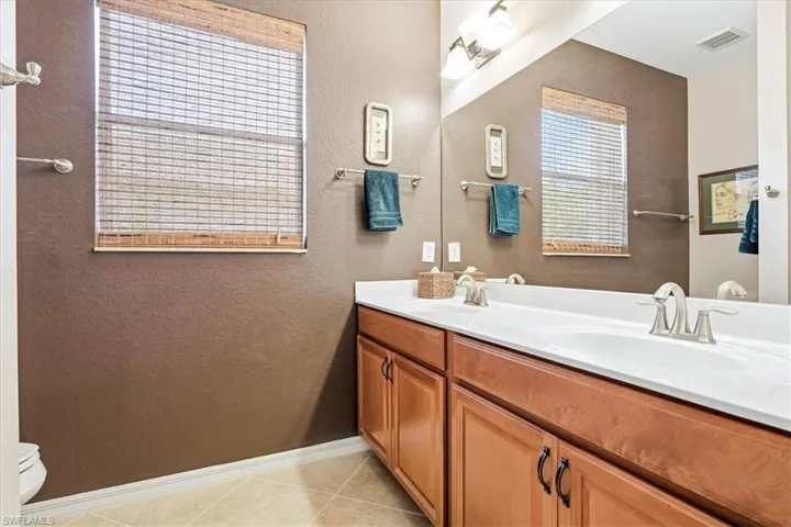 Dual vanity with integrated sinks and brushed nickel faucets