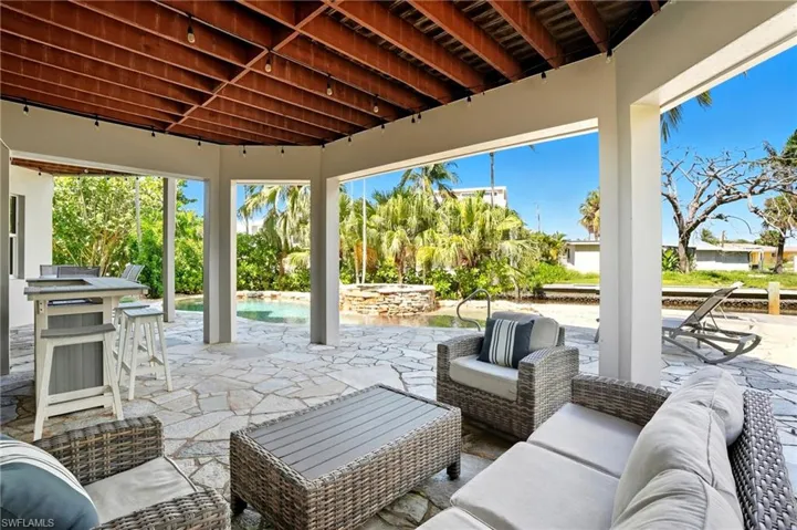 View of patio with an outdoor living space and an outdoor pool - Virtually Edited Image