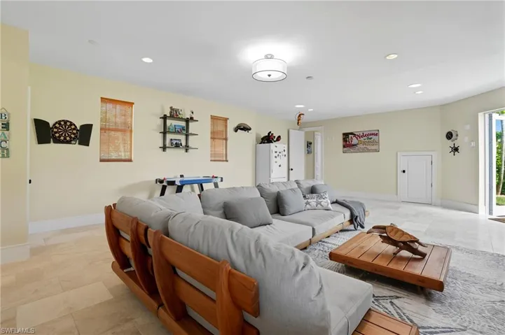 Living area featuring recessed lighting and baseboards - Virtually Edited Image
